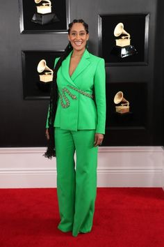 an image of a woman on the red carpet wearing green suit and black hair, smiling