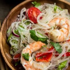 shrimp and noodle salad in a wooden bowl with chopsticks on the side