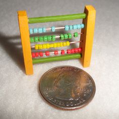 a penny sitting next to an abacus on a table