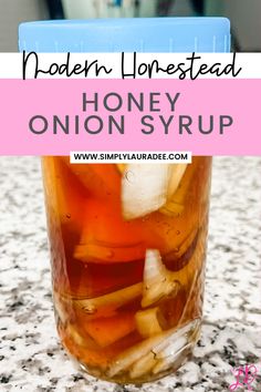 a jar filled with honey onion syrup on top of a marble counter next to a blue container