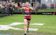 a woman crosses the finish line in a race