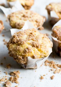 muffins with crumbs sitting on top of a table