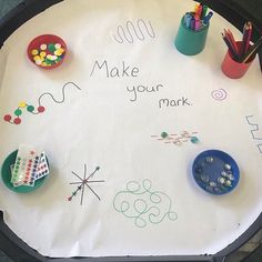 a child's table with writing on it that says make your mark and other crafts