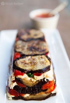 grilled eggplant and tomato sandwich on a white plate