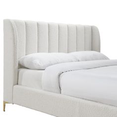 a bed with white linens and pillows on it's headboard, against a white background