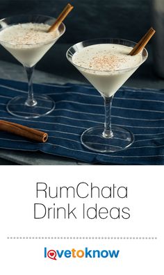 two glasses filled with rumchata drink and cinnamon sticks