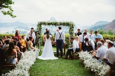 a couple getting married in front of an outdoor ceremony