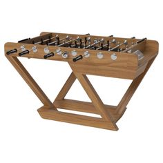 a wooden foosball table with metal knobs on it's sides and legs