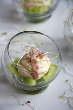 a glass bowl filled with food on top of a table