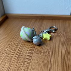 a pair of key chains sitting on top of a wooden table