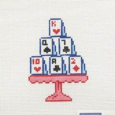 a cross stitch christmas tree is shown on a white background with red, blue and black squares