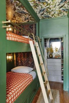 the bunk beds are decorated with colorful wallpaper