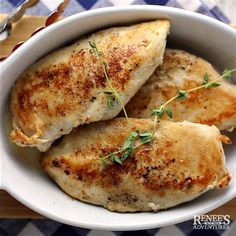 three pieces of chicken in a white bowl