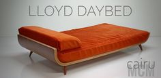 an orange couch sitting on top of a white floor next to a wall with the words lloyd daybed written above it