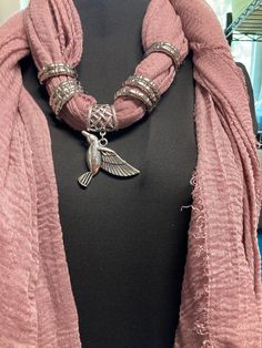 "Mauve colored scarf holds a silver tone clip on Hummingbird pendant. Hummingbird measures 1.5\" long x 2-1/4' wide. Accented with large silver rings. Scarf is viscose fabric with light fringe." Light Fringe, Galaxy Makeup, Hummingbird Pendant, Scarf Necklace, Mauve Color, Scarf Jewelry, Viscose Fabric, Ponchos, Statement Jewelry