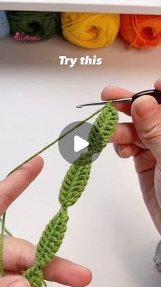 someone crocheting the end of a piece of yarn with their fingers and thumbnails