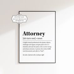 a white wall with a black frame on it and the words'attoriney'written in cursive font