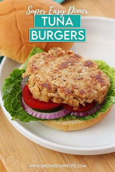 a tuna burger on a bun with lettuce and tomato