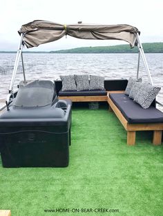 an outdoor lounge area on the back of a boat