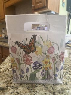 a paper bag with an image of a butterfly on it sitting on a kitchen counter