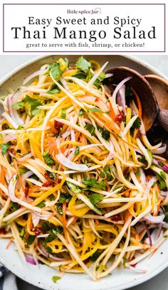 a white bowl filled with salad and topped with shredded carrots, onions, cilantro