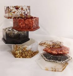 four different colored pieces of glass sitting on top of each other in front of a white background