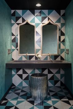 a bathroom with two sinks and mirrors on the wall next to a tiled counter top