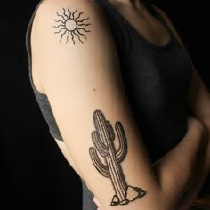 a woman's arm with a tattoo on it and a cactus in the middle