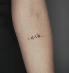 a woman's arm with the word maa tattooed on it