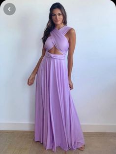 a woman in a purple dress posing for the camera with her hands on her hips