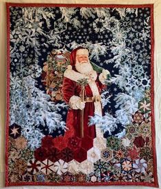 a christmas tapestry hanging on the wall with santa clause and snowflakes around it