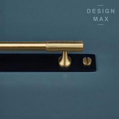 an image of a brass handle on a black door frame with the name design max