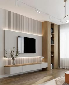 modern living room with white walls and wood flooring, large television on the wall