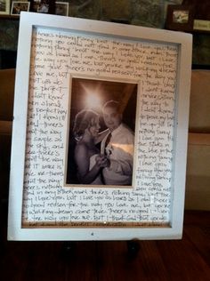 a white frame with writing on it sitting on a table next to a couch and coffee table