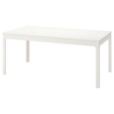 a white table sitting on top of a white floor