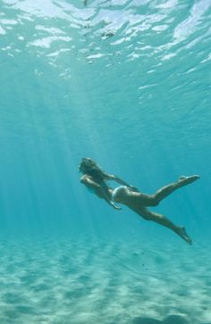 a woman is swimming in the water