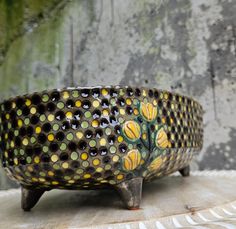 a decorative bowl sitting on top of a wooden table