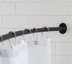 a shower curtain rod with five hooks attached to it