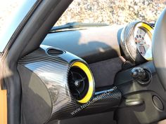 the interior of a car with steering wheel and cup holder on it's dashboard