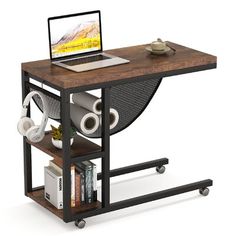 a laptop computer sitting on top of a wooden table next to a shelf with books