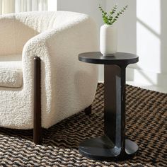 a white chair and black table in a room