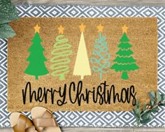 a merry christmas door mat with trees on it next to slippers and planters