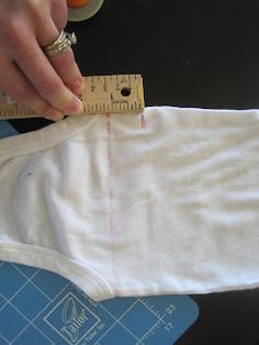 someone is measuring the size of a baby's diaper