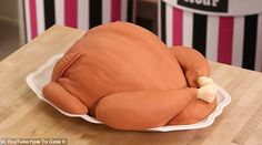 a cake shaped like a turkey sitting on top of a table