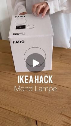 someone is opening up a box with the lid on it that says fado ikea hack mond lampe