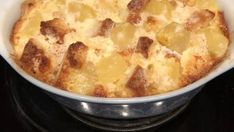 a casserole dish with potatoes and meat in it sitting on a stove top