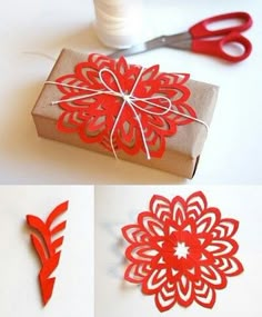 some red paper cut outs sitting on top of a white table next to scissors and a box