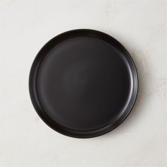 a black plate sitting on top of a white counter