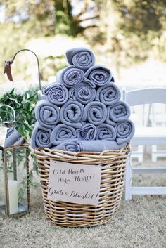 a basket filled with lots of blue towels