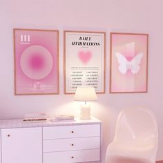 a white dresser sitting next to a wall with posters on it